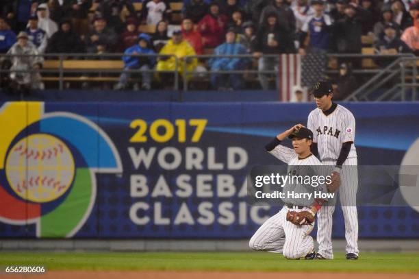 Hayato Sakamoto of team Japan reacts to his catch alongside teammate Shogo Akiyama to end the fourth inning against the United States during Game 2...