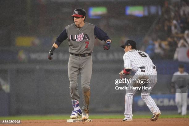 Christian Yelich of team United States reacts to a standup double against Hayato Sakamoto of team Japan in the fourth inning during Game 2 of the...