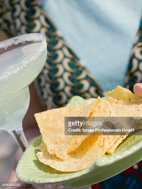 woman holding glass of margarita & tortilla chips (mexico) - americana aloe stock pictures, royalty-free photos & images