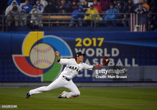 Hayato Sakamoto of Team Japan reaches to make a catch to end the fourth inning of Game 2 of the Championship Round of the 2017 World Baseball Classic...