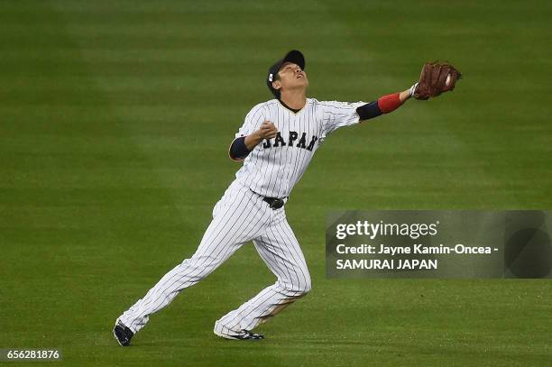 Hayato Sakamoto of team Japan makes a catch off a pop up by Buster Posey of team United States to end the fourth inning during Game 2 of the...