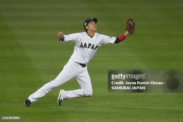 Hayato Sakamoto of team Japan makes a catch off a pop up by Buster Posey of team United States to end the fourth inning during Game 2 of the...