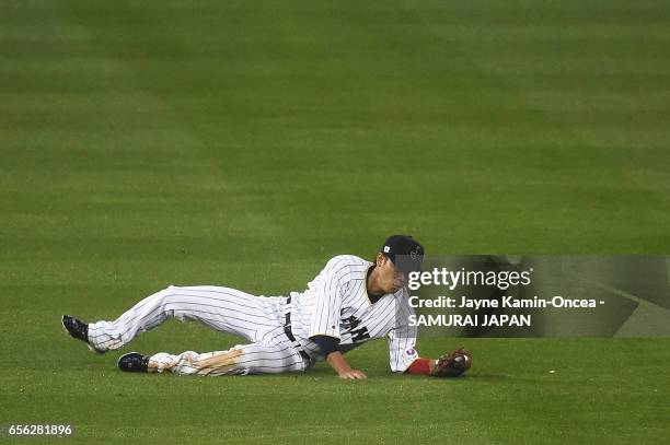 Hayato Sakamoto of team Japan makes a catch off a pop up by Buster Posey of team United States to end the fourth inning during Game 2 of the...