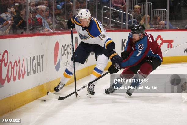 John Mitchell of the Colorado Avalanche defends against Jay Bouwmeester of the St. Louis Blues at the Pepsi Center on March 21, 2017 in Denver,...