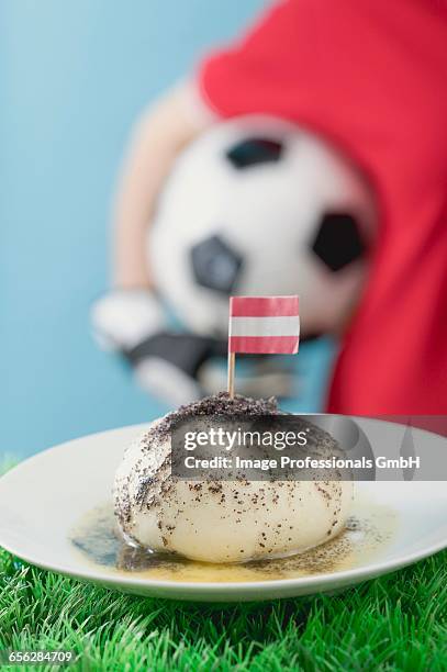 yeast dumpling with flag, footballer in background - fat soccer players stock pictures, royalty-free photos & images