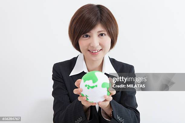 japanese female company employee with a globe - newbie stock pictures, royalty-free photos & images