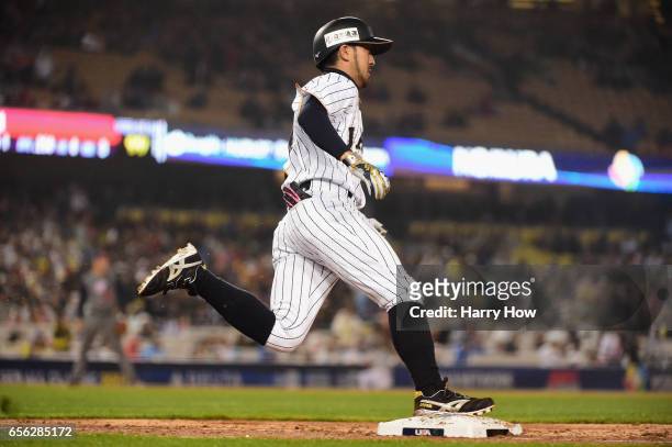 Ryosuke Kikuchi of team Japan rounds the bases after a game-tying home run in the sixth inning against team United States during Game 2 of the...