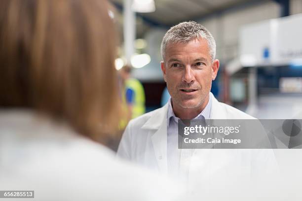 engineers talking in steel factory - selective focus stock pictures, royalty-free photos & images