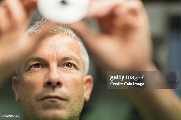 focused worker examining part in steel factory - worker inspecting steel foto e immagini stock