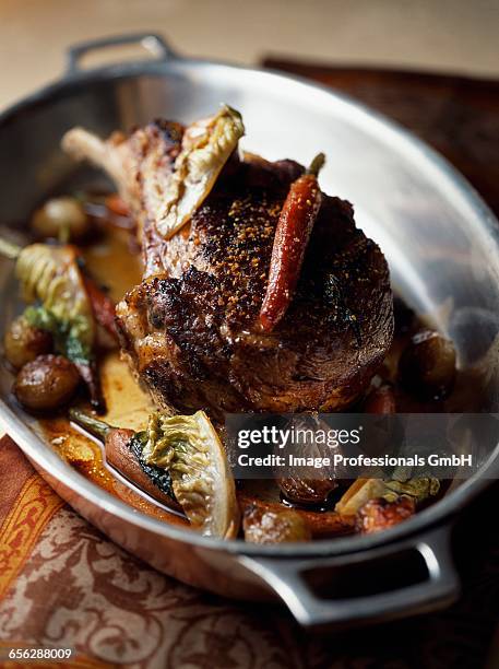 veal chop cooked in a casserole dish with braised lettuce and carrots - lattuga stock pictures, royalty-free photos & images