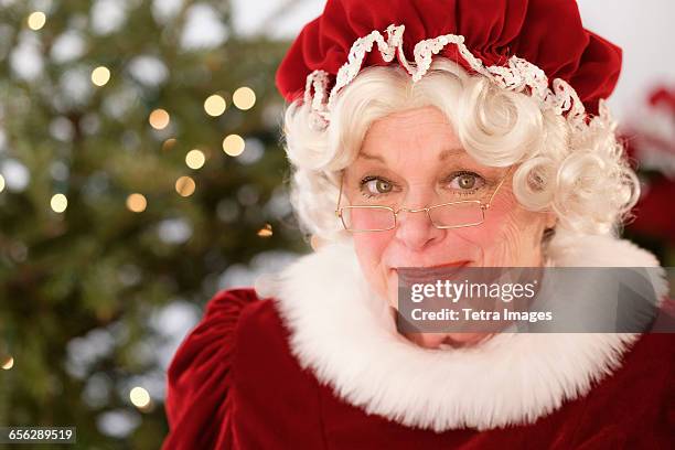 portrait of smiling mrs. claus - mrs claus stock pictures, royalty-free photos & images