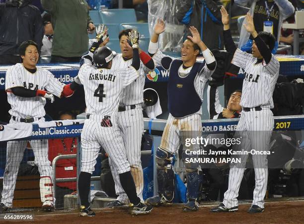 Ryosuke Kikuchi of team Japan celebrates his game-tying home run with teammates in the sixth inning against team United States during Game 2 of the...