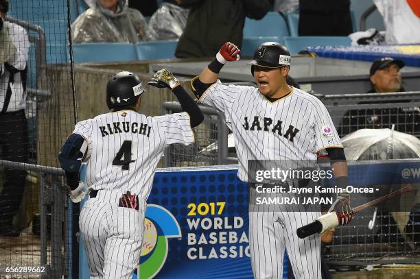 Ryosuke Kikuchi of team Japan celebrates his game-tying home run with teammate Norichika Aoki in the sixth inning against team United States during...