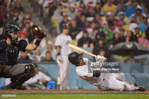 Norichika Aoki of team Japan dives away from an inside pitch in the eighth inning against team United States during Game 2 of the Championship Round...