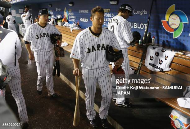 Infielder Sho Nakata and Outfielder Yoshitomo Tsutsugoh of Japan leave the dugout past Infielder Nobuhiro Matsuda of Japan after the World Baseball...