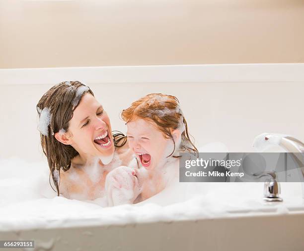 mother and daughter (4-5) having bubble bath - lehi stock pictures, royalty-free photos & images