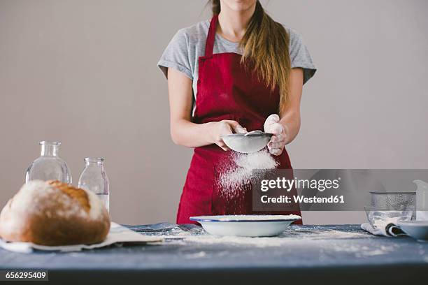 woman preparing home made bread, sieving the flour - sieve stock pictures, royalty-free photos & images