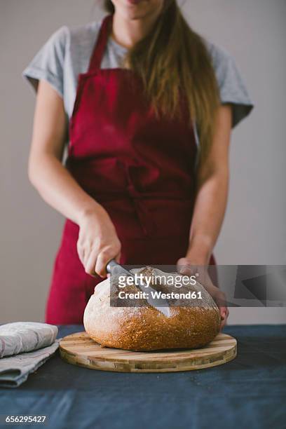 woman chopping fresh hand made bread - baker smelling bread photos et images de collection