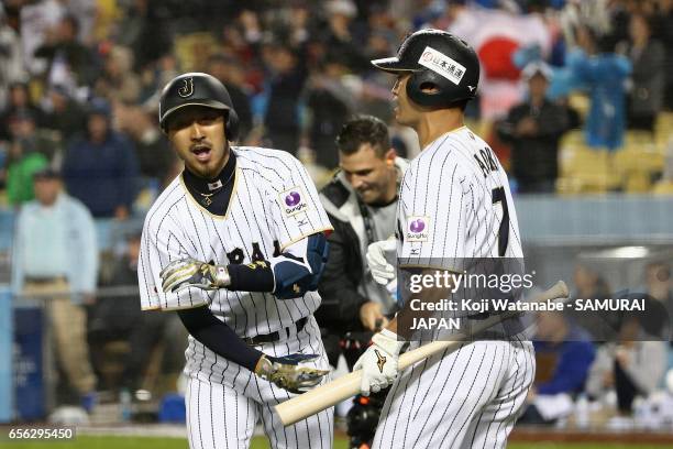 Infielder Ryosuke Kikuchi of Japan celebrates after hitting a solo homer with Outfielder Norichika Aoki in the bottom of the sixth inning during the...
