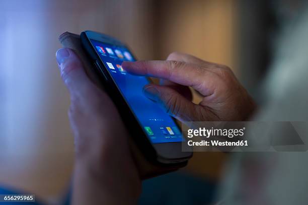 hands of senior touching smartphone - app stock-fotos und bilder