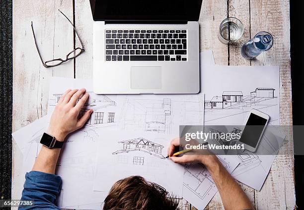 architect working at desk with laptop, making sketches - architect sketching stock pictures, royalty-free photos & images