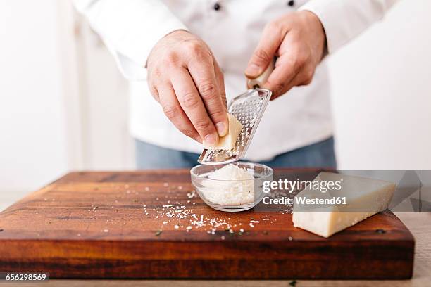 chef preparing stuffing for ravioli, grating parmesan cheese - grattugia foto e immagini stock