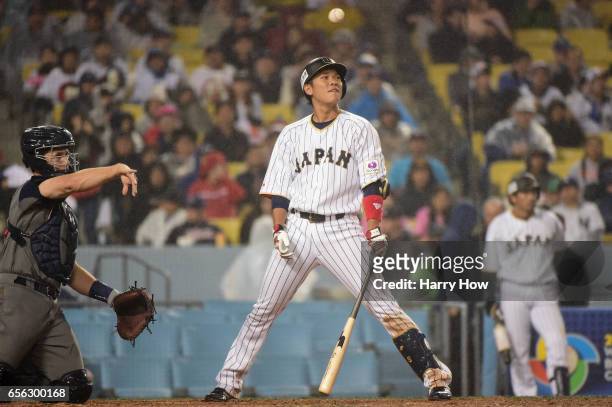 Hayato Sakamoto of team Japan reacts to a strike as catcher Buster Posey of team United States returns the ball in the seventh inning during Game 2...