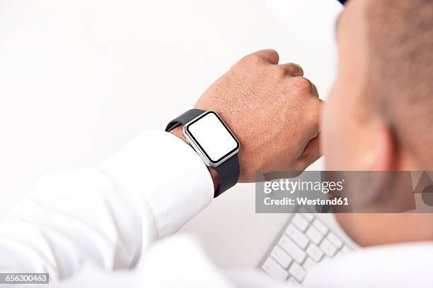 man looking at his smartwatch, close-up - smart watch on wrist stock pictures, royalty-free photos & images