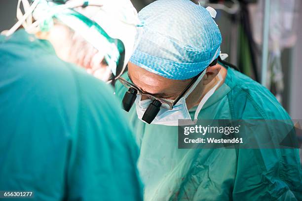 heart surgeons during a heart operation - heart surgery stock pictures, royalty-free photos & images