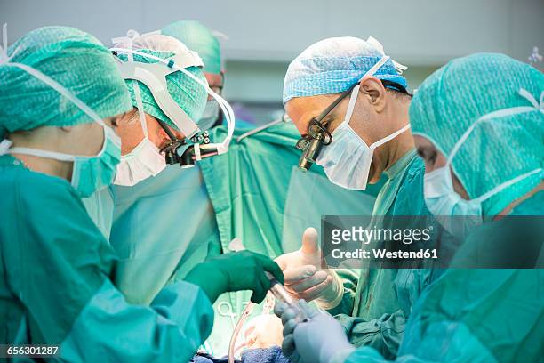 heart surgeons during a heart operation - heart surgery stock pictures, royalty-free photos & images