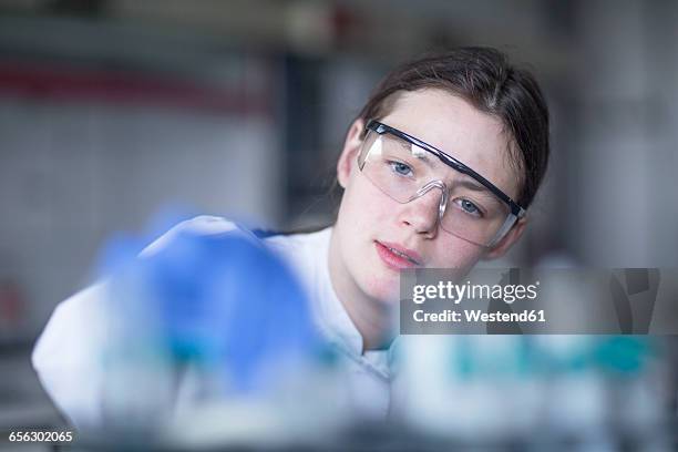 lab technician examining sample - scientist portrait stock pictures, royalty-free photos & images