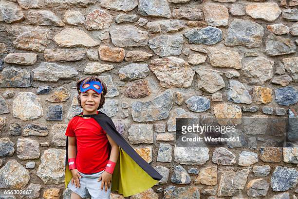 little big hero with a mask against a stone wall - big hero 6 film stock-fotos und bilder