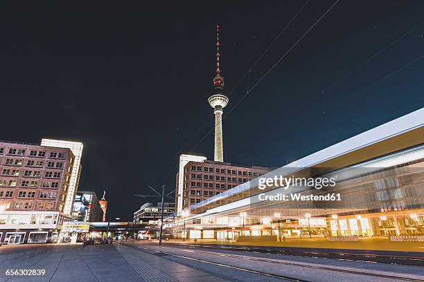 germany, berlin, alexanderplatz and tv tower at night, light trail of tramway - alex stockfoto's en -beelden