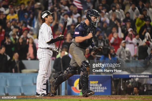 Nobuhiro Matsuda of team Japan reacts after a strikeout to end the game as Buster Posey of team United States celebrates to the mound after the...