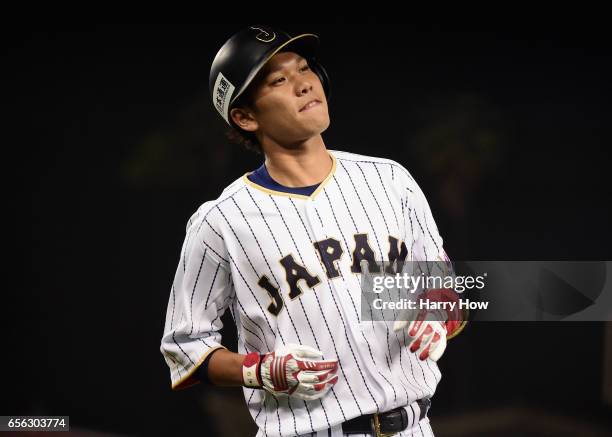 Hayato Sakamoto of team Japan reacts to his groundout in the ninth inning against the United States during Game 2 of the Championship Round of the...