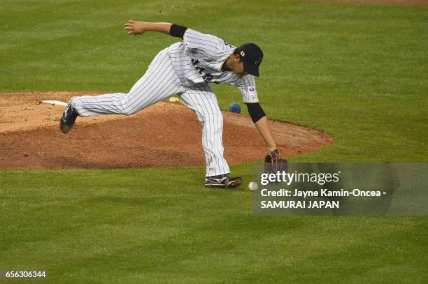 Tomoyuki Sugano of team Japan fields a ball in the fifth inning against the United States during Game 2 of the Championship Round of the 2017 World...