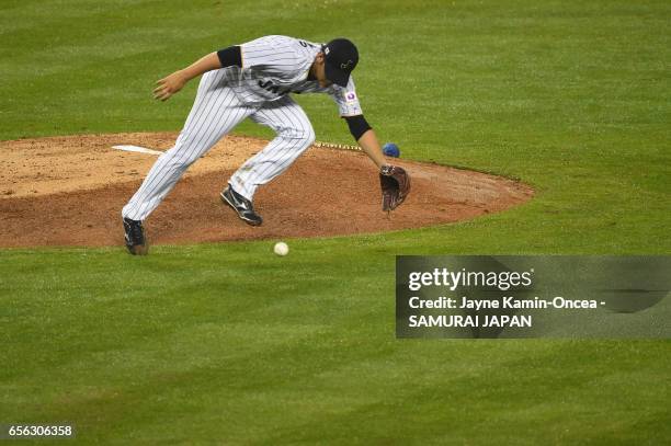 Tomoyuki Sugano of team Japan fields a ball in the fifth inning against the United States during Game 2 of the Championship Round of the 2017 World...