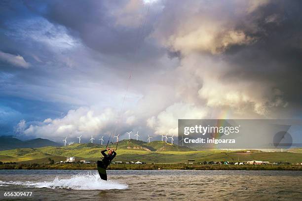 man kite surfing at los lances lagoon, tarifa, andalucia, spain - kite lagoon stock-fotos und bilder