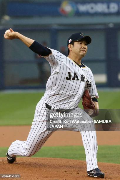 Starting pitcher Tomoyuki Sugano of Japan throws in the top of the first inning during the World Baseball Classic Championship Round Game 2 between...