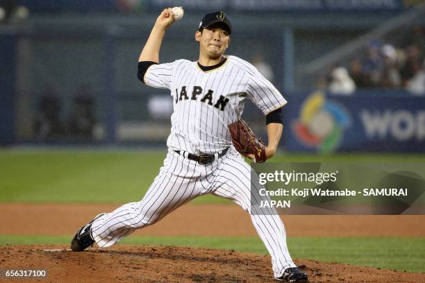 Starting pitcher Tomoyuki Sugano of Japan throws in the top of the first inning during the World Baseball Classic Championship Round Game 2 between...