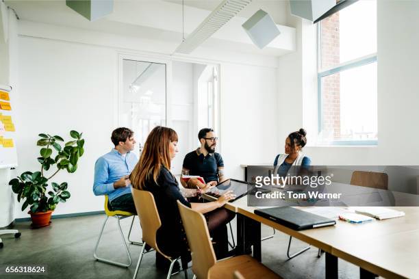 group of new business people having a meeting in modern office - four people stockfoto's en -beelden