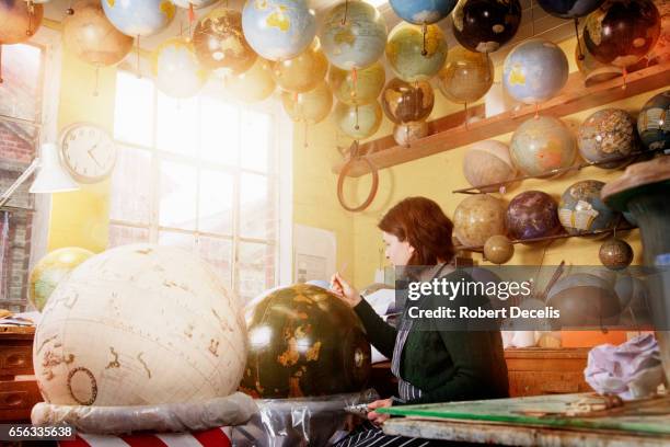 globe maker in workshop painting globe by hand - to assemble world stock pictures, royalty-free photos & images