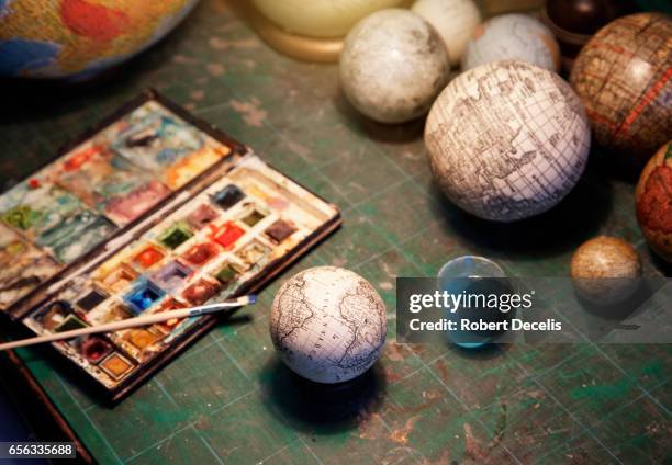 globe makers pallette of paints and brush with globes - world heritage stock pictures, royalty-free photos & images