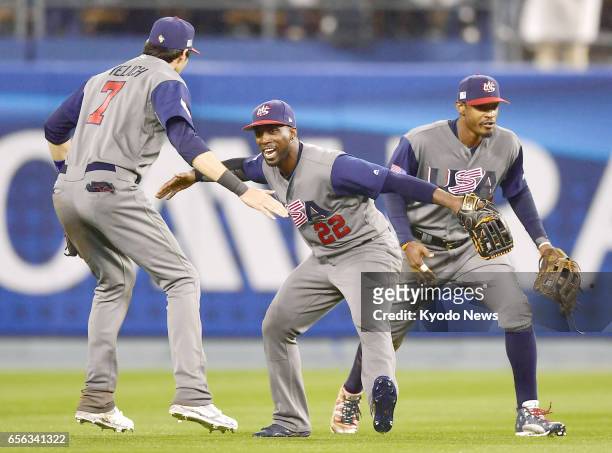 Outfielders Christian Yelich, Andrew McCutchen and Adam Jones celebrate after a 2-1 win over Japan in the semifinals of the World Baseball Classic at...