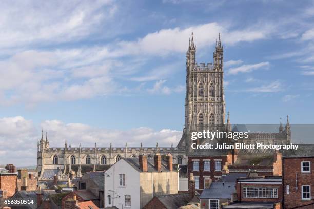 gloucester cathedral across the rooftops. - gloucester cathedral stock pictures, royalty-free photos & images