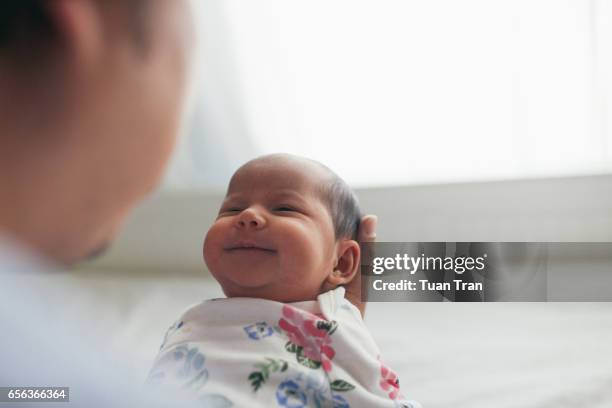 father holding newborn daughter - newborn bildbanksfoton och bilder