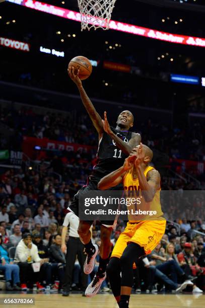 Jamal Crawford of the Los Angeles Clippers attempts a lay up againstJames Jones of the Cleveland Cavaliers on March 18, 2017 at STAPLES Center in Los...