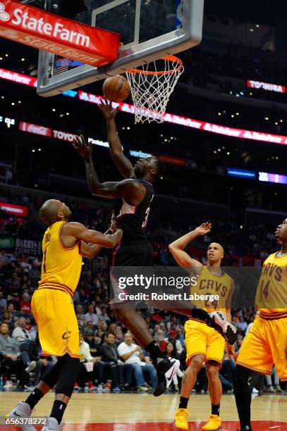 Wesley Johnson of the Los Angeles Clippers attempts a lay up against James Jones of the Cleveland Cavaliers on March 18, 2017 at STAPLES Center in...