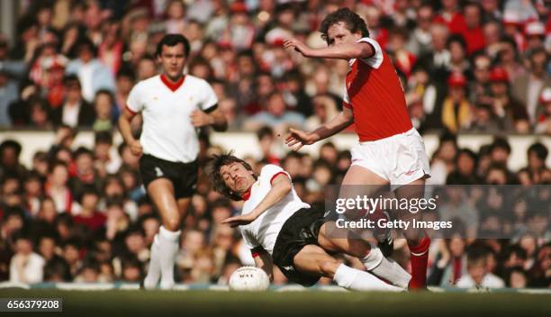 Arsenal player Peter Nicholas evades a challenge from Liverpool winger Steve Heighway as Ray Kennedy looks on during a First Division match at...