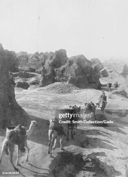 Camel caravan passes through the desert near Memphis, Egypt, 1922. .